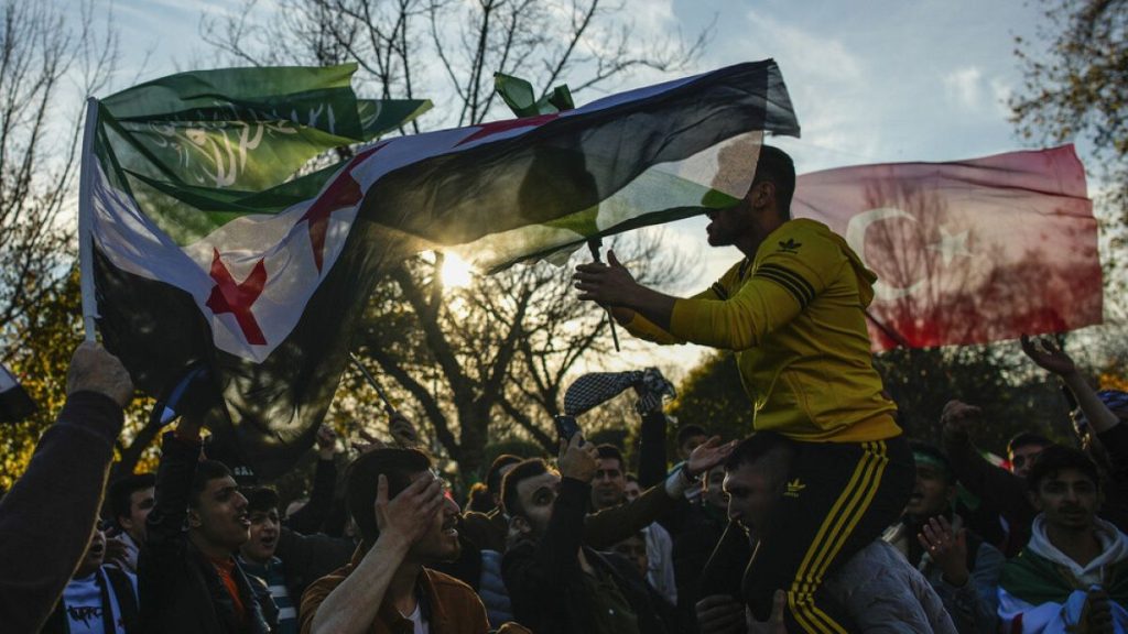 FILE: People gather to celebrate the Syrian government