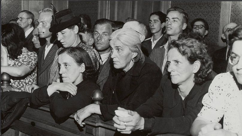 People stand in the public gallery at the first session of the Tribunal for Special Jurisdiction in Den Bosch, the Netherlands, in July 1945.