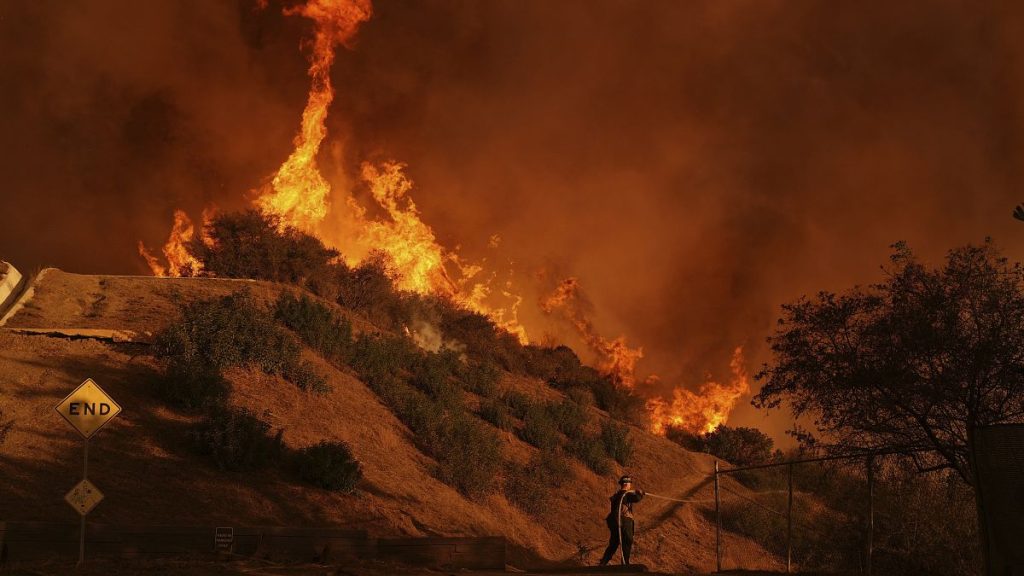 A firefighter battles the Palisades Fire in Mandeville Canyon in Los Angeles, 11 January, 2025