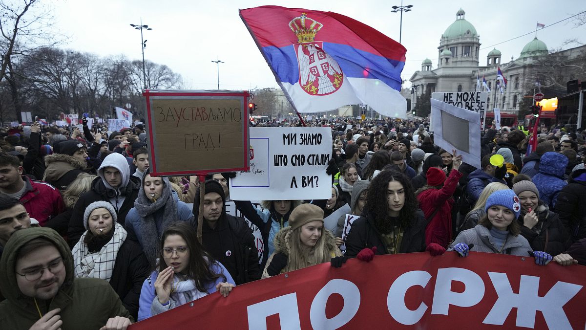 People gather in front of Serbia