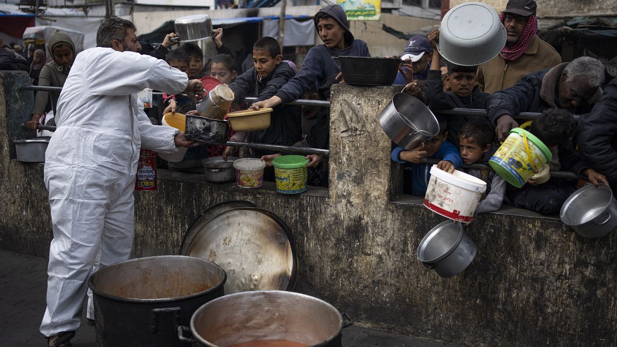 Palestinians line up for free food in Rafah, Gaza Strip.