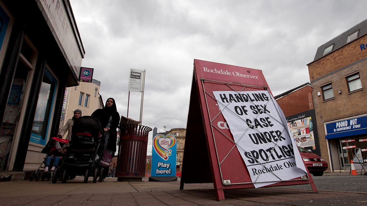 A newspaper advertising board in Rochdale, England during the emergence of one of a series of