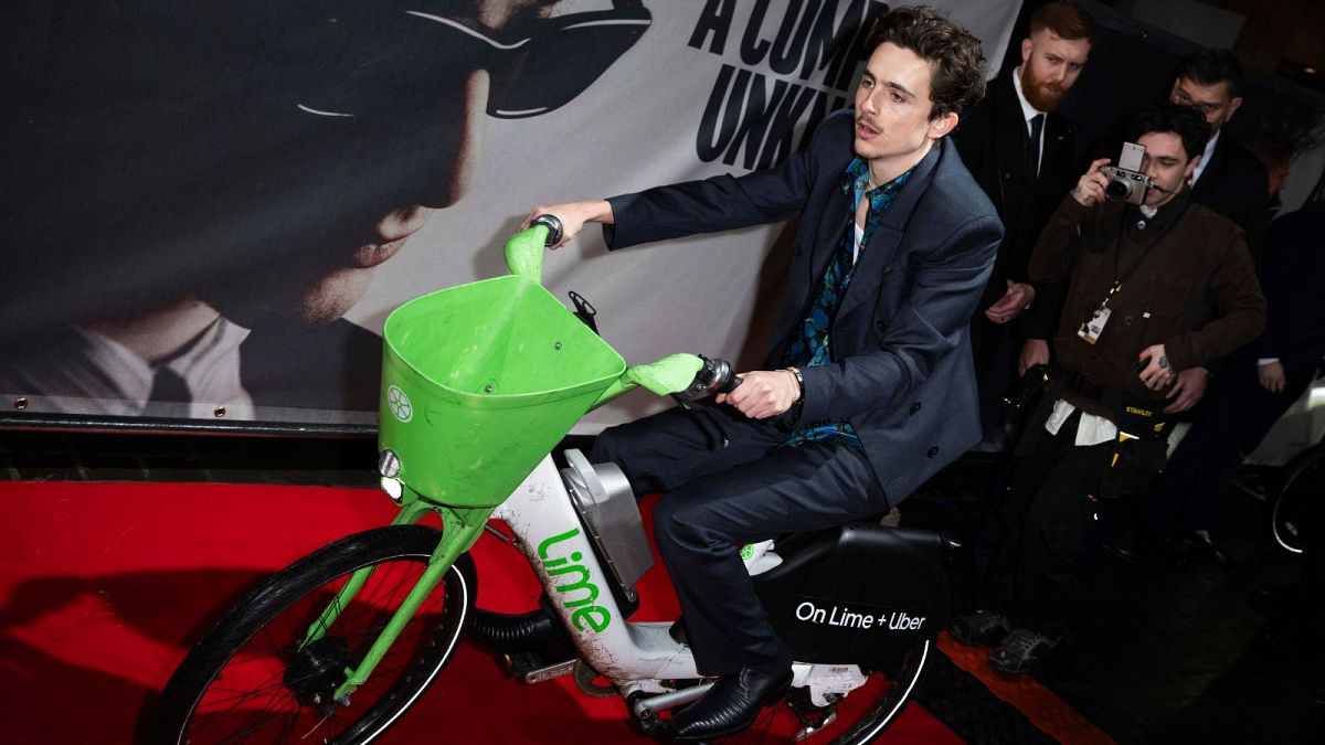 Timothée Chalamet rides an e-bike at the premiere of