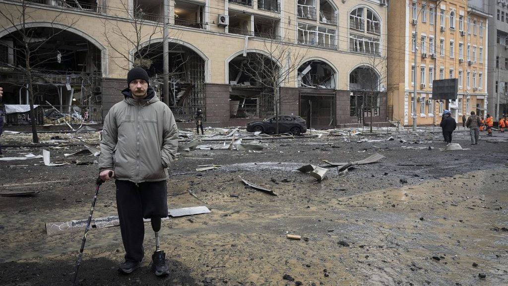 A former soldier looks at the buildings destroyed by recent Russian attacks in Kyiv, 20 December, 2024