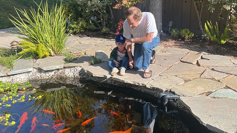 Craig avec son petit-fils Henry à l'étang de carpes koï du couple.