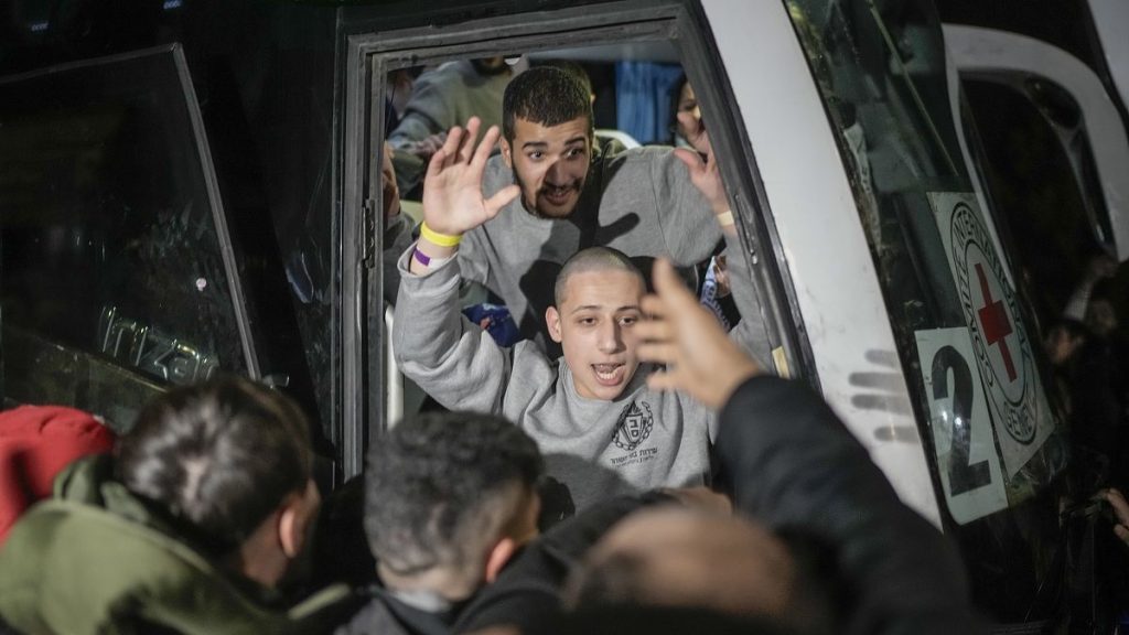 A Palestinian prisoner is greeted as he disembarks from a bus after being released from an Israeli prison in Beitunia, 20 January, 2025