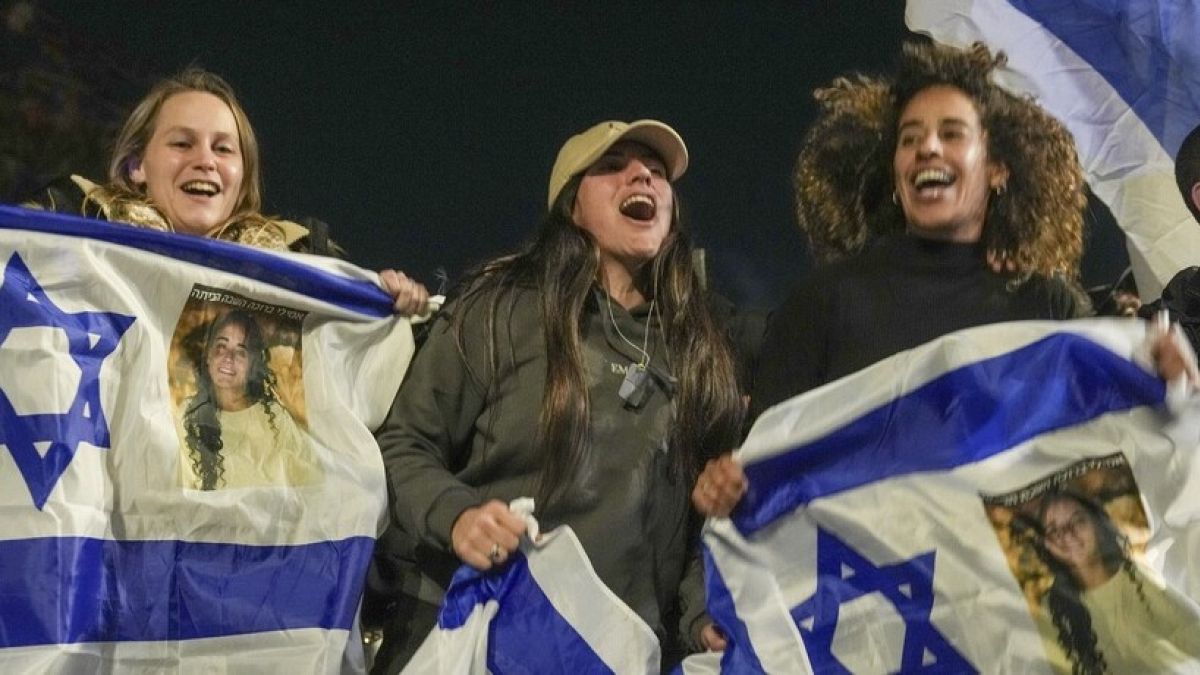 Israelis celebrate the release of three hostages who had been held captive by Hamas in Gaza as they gather in Tel Aviv, Israel, Sunday, Jan. 19, 2025