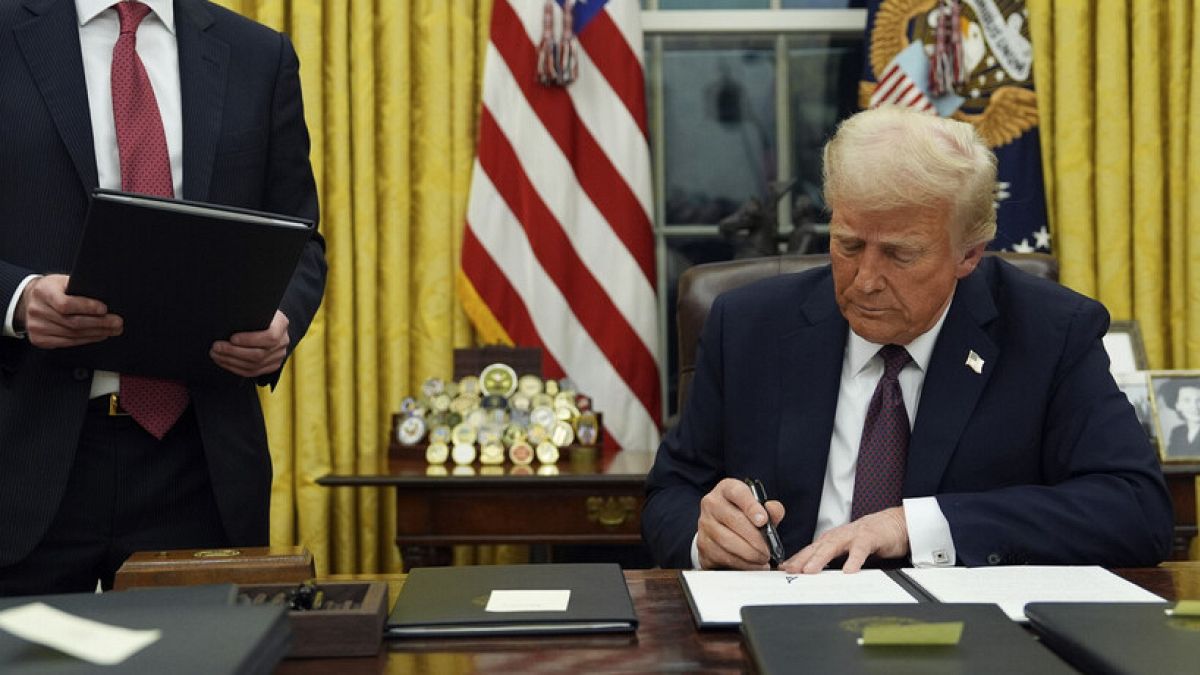 President Donald Trump signs an executive order to create the Department of Government Efficiency (DOGE) in the Oval Office of the White House, Monday, Jan. 20, 2025