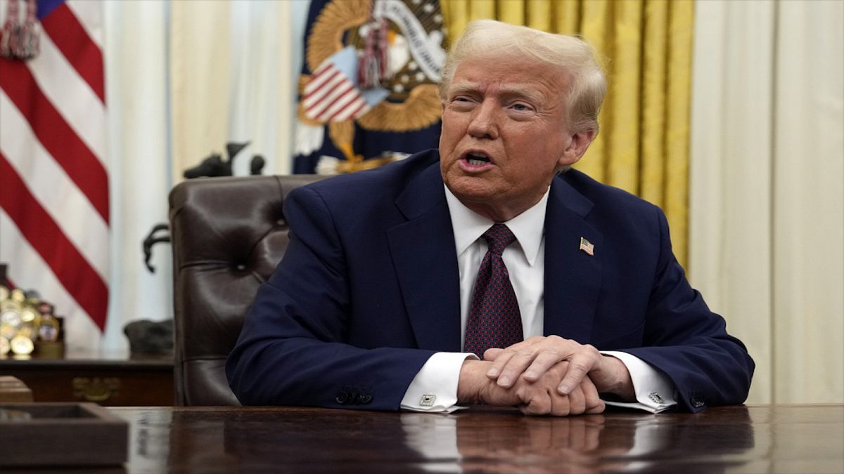 President Donald Trump answers questions from reporters as he signs an executive orders in the Oval Office of the White House, Thursday, Jan. 23, 2025, in Washington.