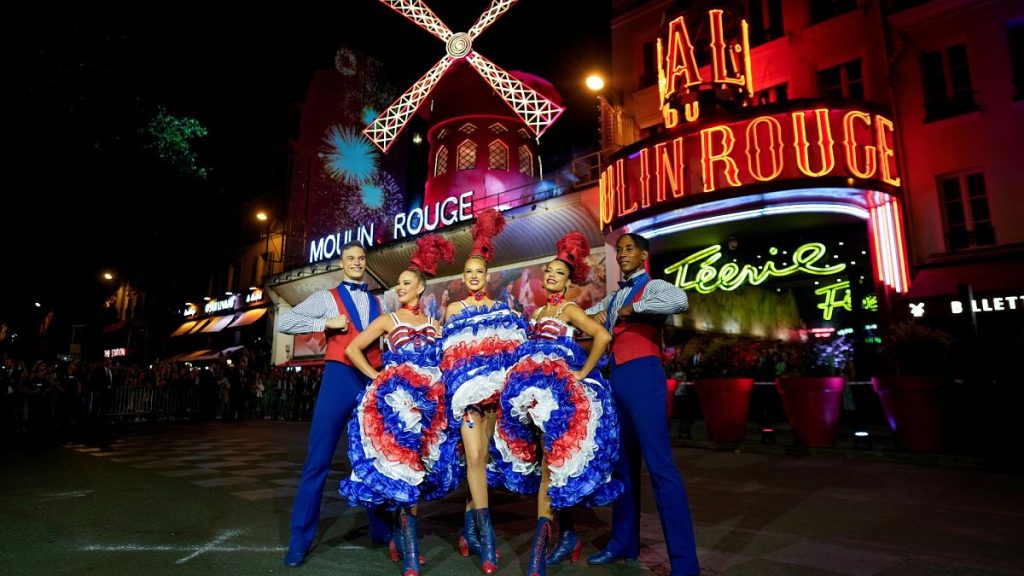 Dancers perform in front of the Moulin Rouge cabaret during the inauguration of the theatre