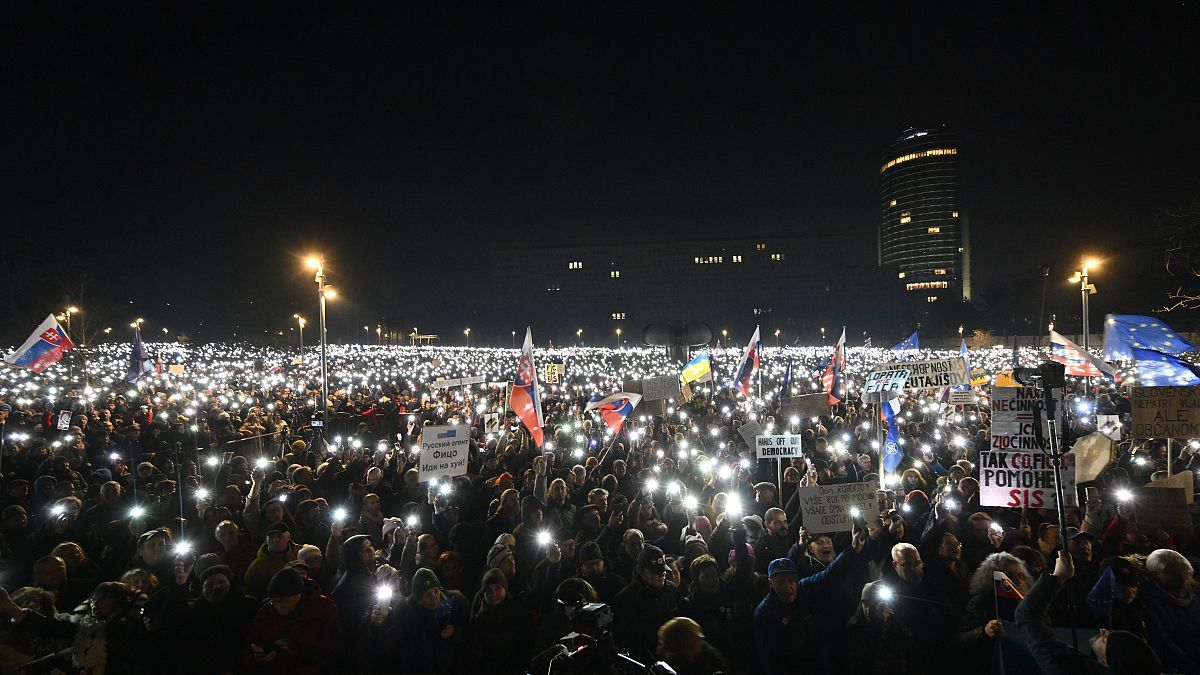 People light up their phones as thousands gather to oppose the policies of populist Prime Minister Robert Fico in Bratislava, 24 January, 2025