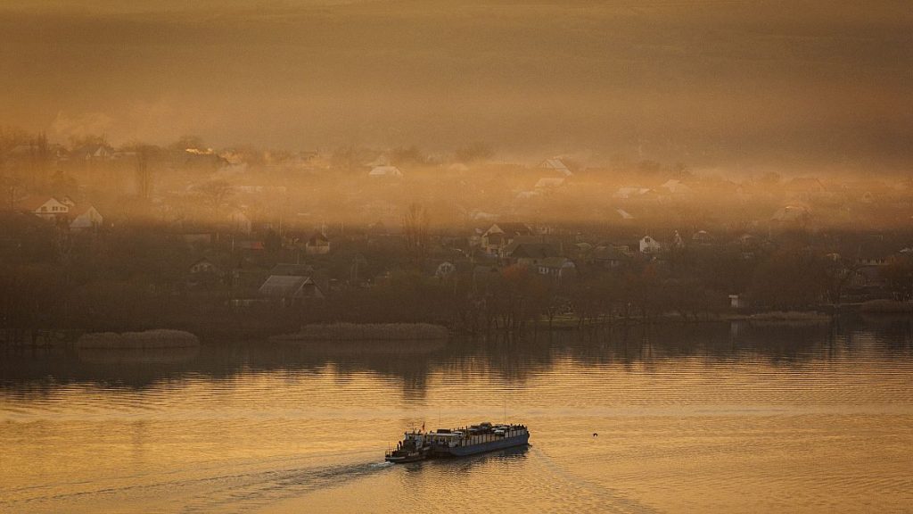 A ferry sails to the left bank of the Dniester River, the border between Moldova and Transnistria, seen from Moldova, 8 January, 2025