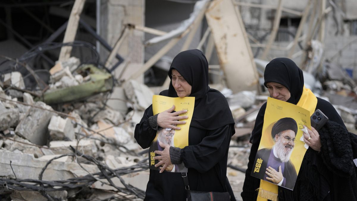 Lebanese women hold portraits of of slain Hezbollah leader Sayyid Hassan Nasrallah,  Israel, south Lebanon, Sunday, Jan. 26, 2025.