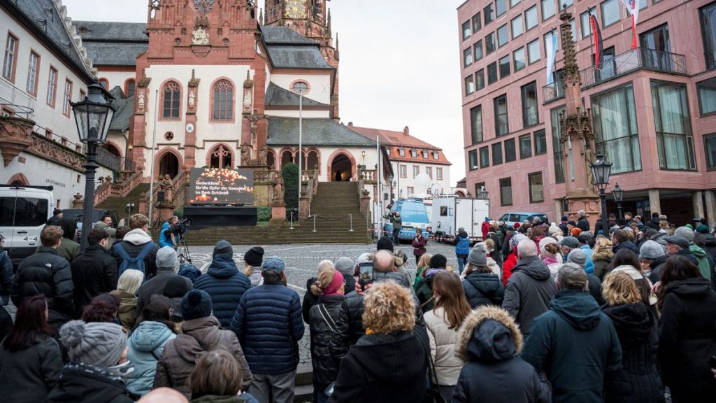 People gather in Aschaffenburg to honour a child and a man killed in a knife attack.