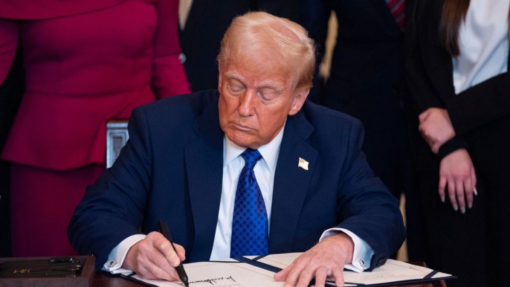 President Donald Trump signs the Laken Riley Act during in the East Room of the White House.