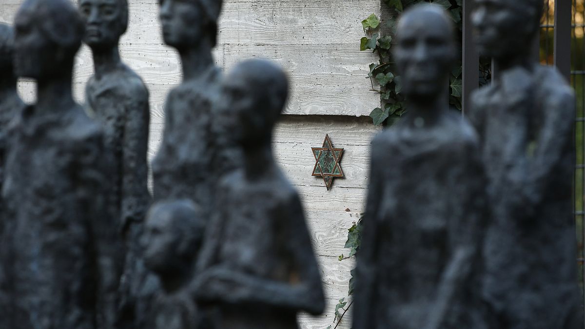 FILE - A star of David behind a sculpture by German artist Will Lammert is pictured at a Jewish cemetery and memorial in Berlin, Germany, Thursday, Oct. 31, 2013