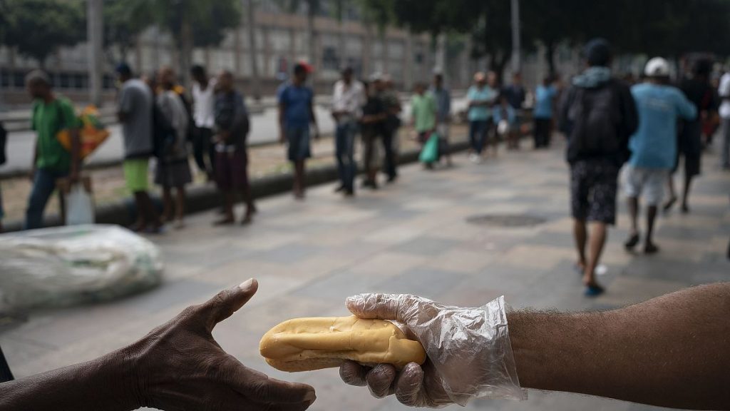 Homeless people gather for coffee and bread in Rio de Janeiro, Brazil, in March 2020.