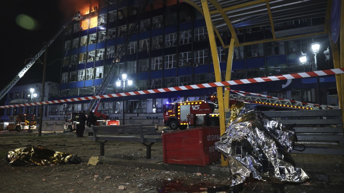 Dead bodies of people killed in a Russian airstrike are seen at a tram station in Zaporizhzhia, Ukraine, Wednesday Jan. 8, 2025.