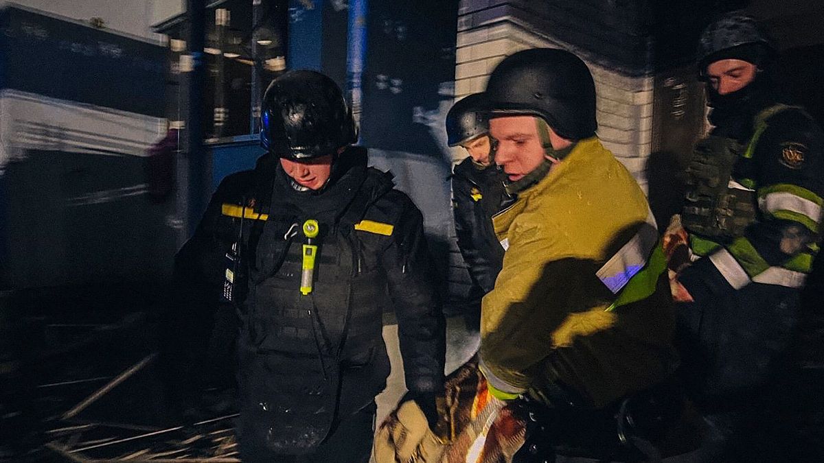 Emergency services personnel carry the body of a local resident after a Russian drone attack in Kyiv region, Ukraine, Friday, Jan. 24, 2025.