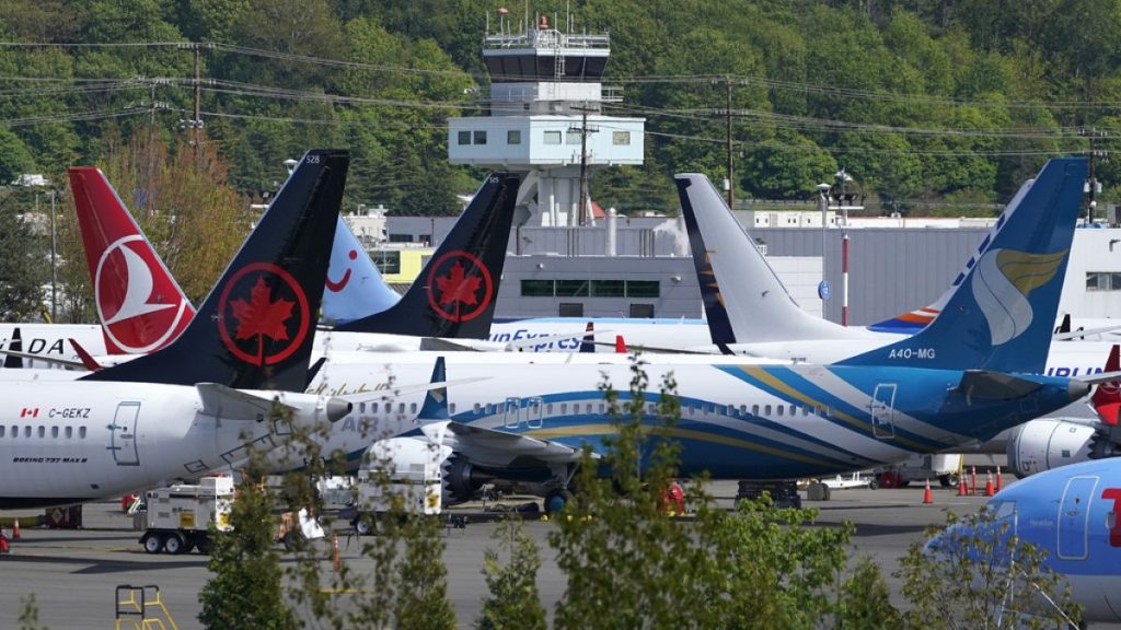 Boeing 737 Max airplanes, belonging to Air Canada and other airlines, sit parked in a storage lot, Monday, April 26, 2021