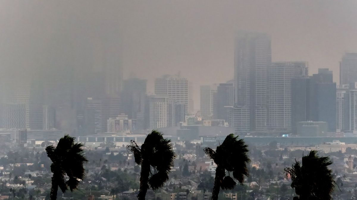 High winds blow as thick smoke from wildfires shrouds downtown Los Angeles on Wednesday, Jan. 8, 2025.