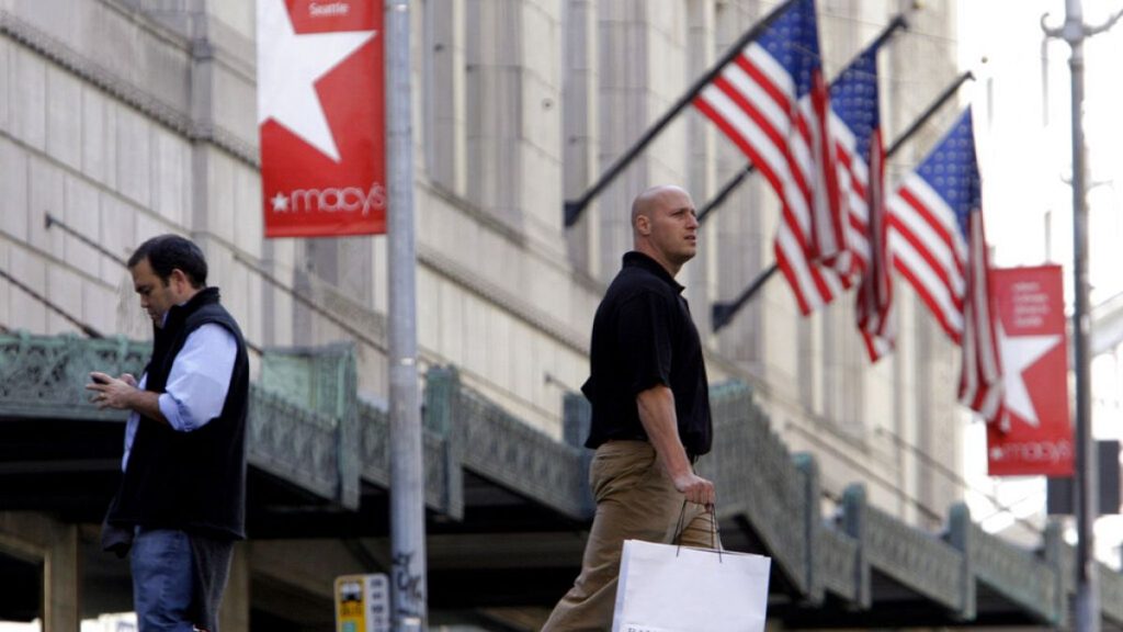 Shoppers walk past a Macy