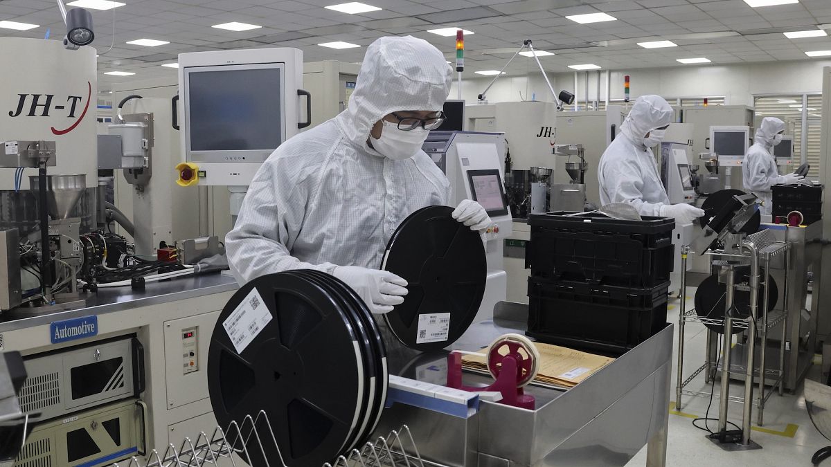 File picture of Workers inspect items at a chip maker in Binzhou city in east China