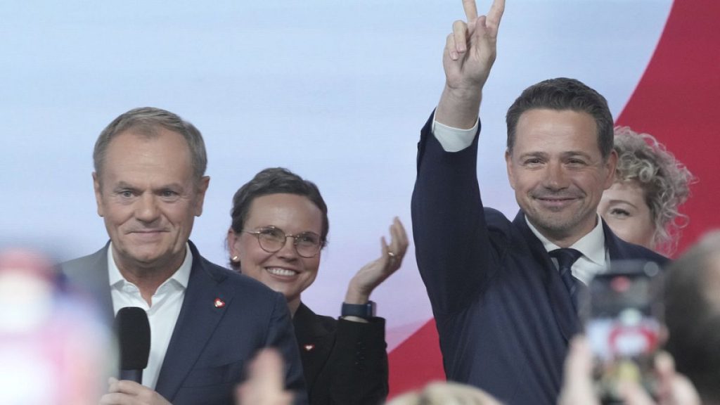 Rafał Trzaskowski, standing next to Prime Minister Donald Tusk (left)