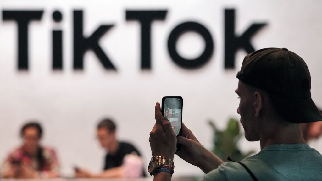 A visitor makes a photo at a TikTok exhibition in Germany in this 2022 file photo.