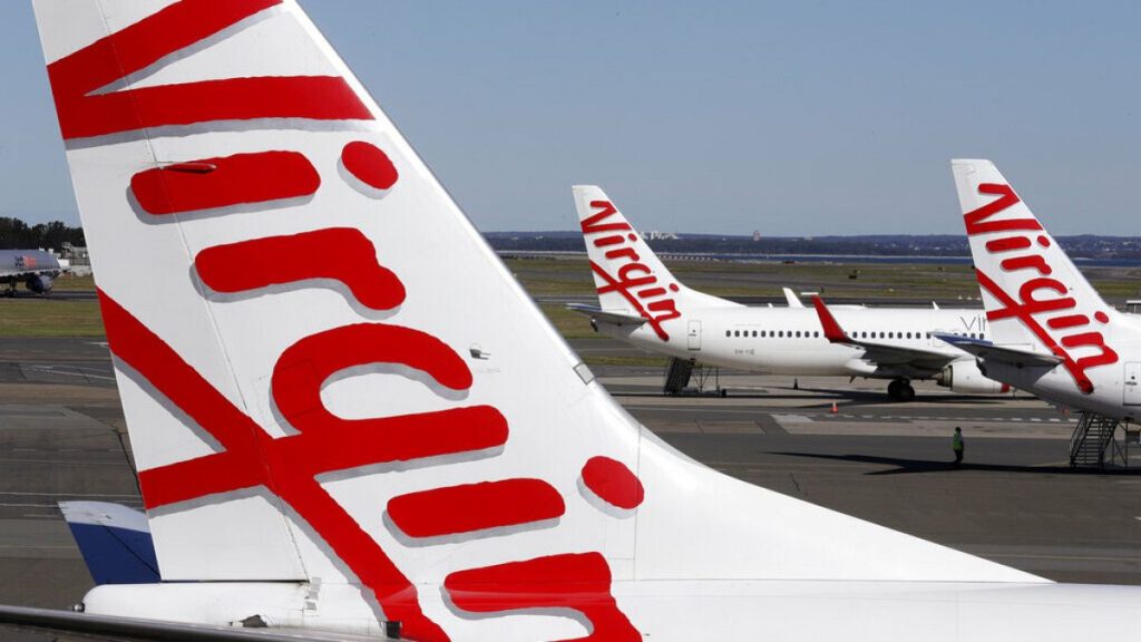 FILE: Virgin Australia planes are parked at terminal at Sydney Airport in Sydney, Wednesday, Aug. 5, 2020.