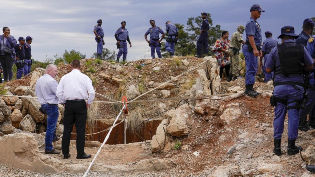 FILE: Police officers and security personnel stand by the opening of a reformed gold mineshaft where illegal miners are trapped in Stilfontein, South Africa, 15 November, 2024