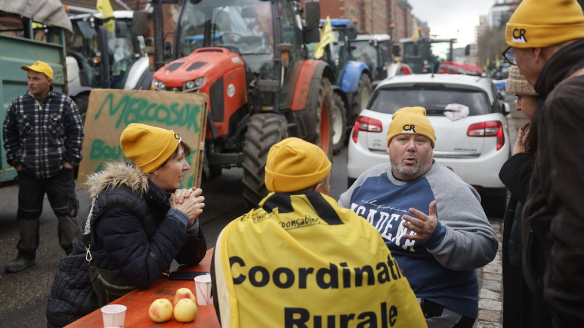 Farmers block a street as they demonstrate against the Mercosur trade deal treaty, Tuesday, Nov. 26, 2024 in Strasbourg, eastern France. (AP Photo/Jean-Francois Badias)