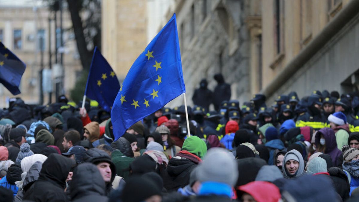 Demonstrators with EU flags rally outside the parliament to protest against the government