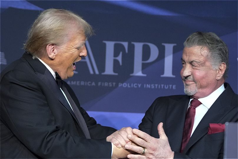 Le président élu Donald Trump salue l'acteur Sylvester Stallone lors d'un gala de l'America First Policy Institute dans son domaine de Mar-a-Lago le 14 novembre 2024.