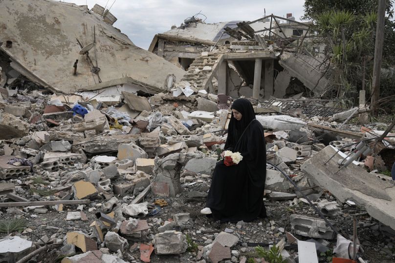 Une Libanaise est assise sur les décombres d'une maison détruite par l'offensive aérienne et terrestre israélienne, à Aita al-Shaab, dans le sud du Liban, le dimanche 26 janvier 2025.