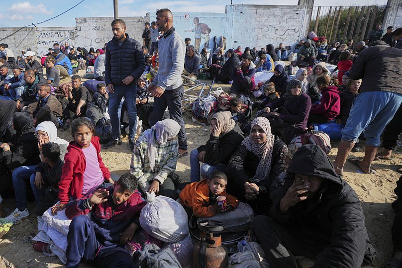 Des Palestiniens attendent avec leurs affaires dans le centre de Gaza dans l'espoir de retourner au nord, le 25 janvier 2025.