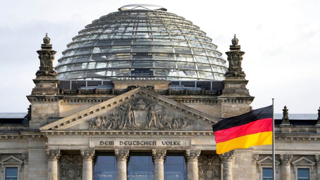 A national flag of Germany waves in front of the Reichag building, home of the German federal parliament Bundestag, in Berlin, Germany, Monday, Jan. 3, 2022.