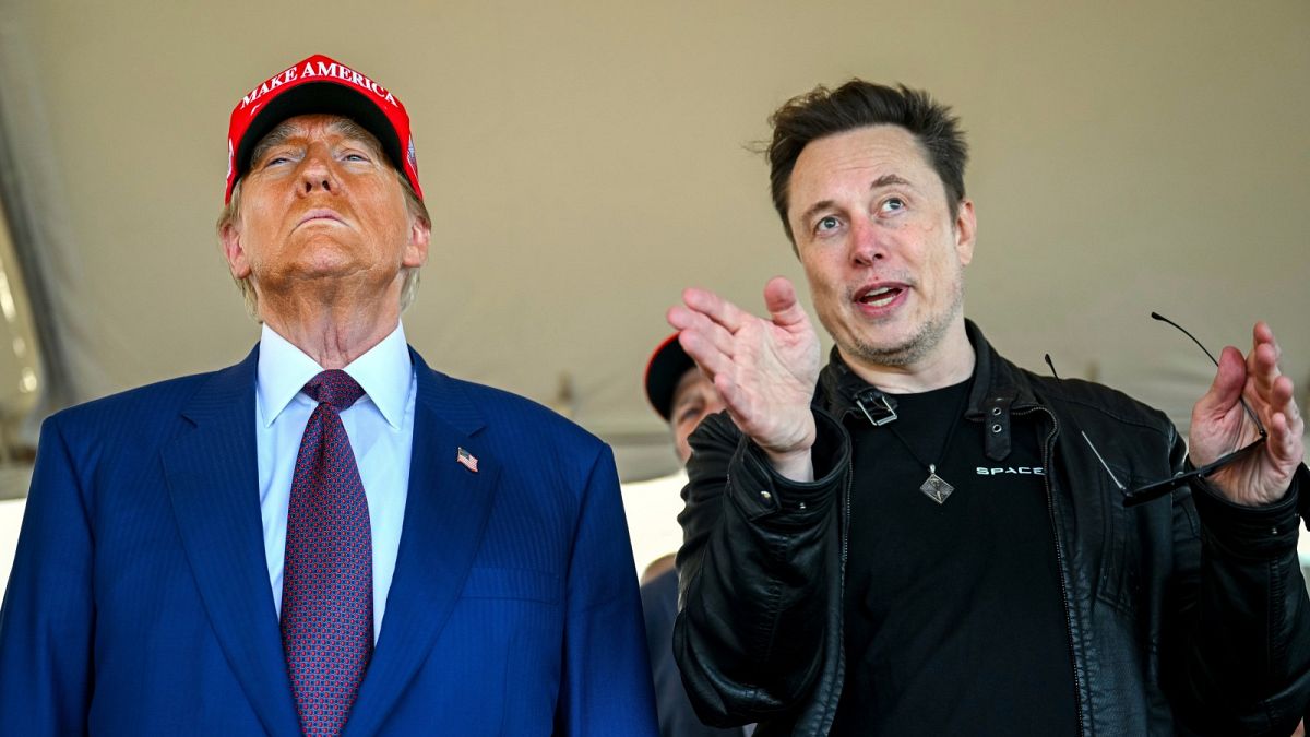 President-elect Donald Trump listens to Elon Musk as he arrives to watch SpaceX