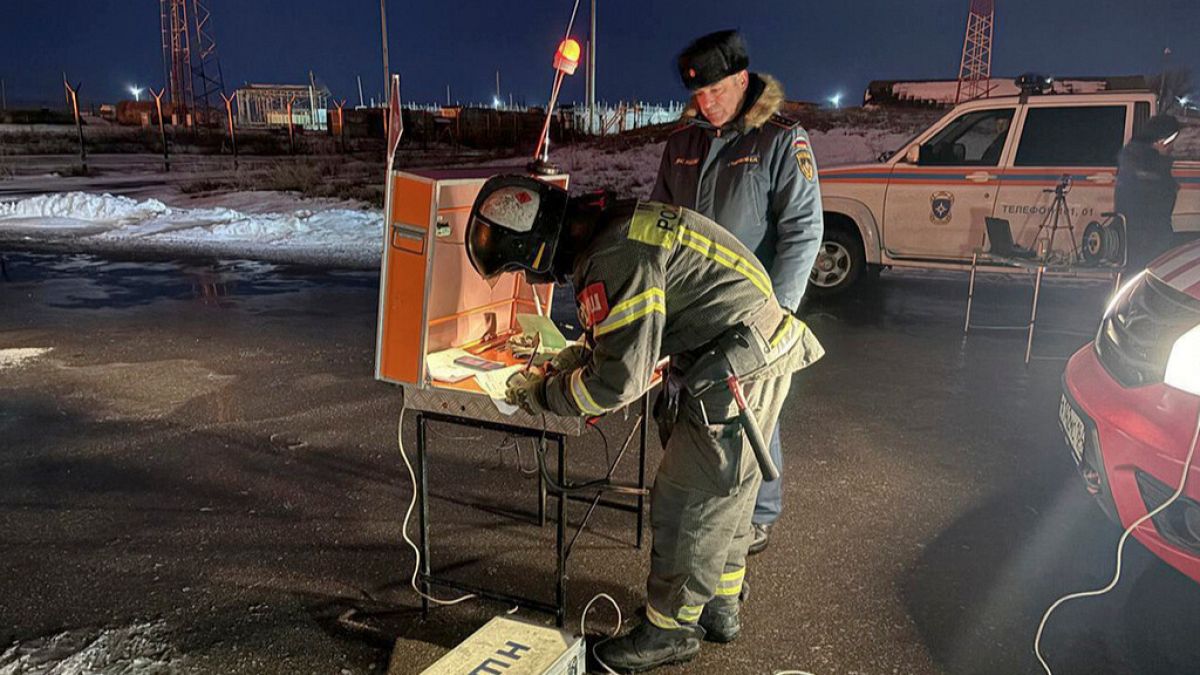 Firefighters and rescuers work at the industrial side damaged after Ukrainian drones