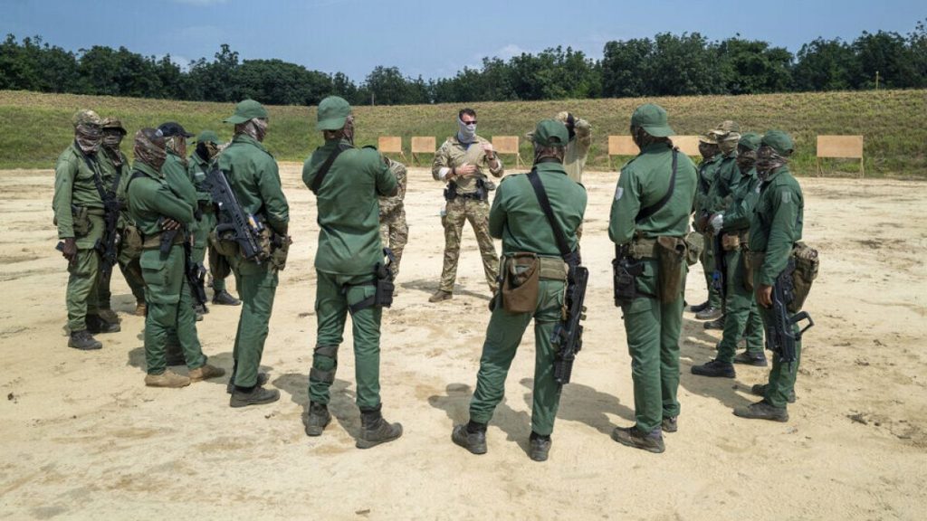 FILE: A Dutch military instructor briefs Ivorian special forces soldiers at base camp Loumbila, Jacqueville, Ivory Coast, Feb. 17, 2022