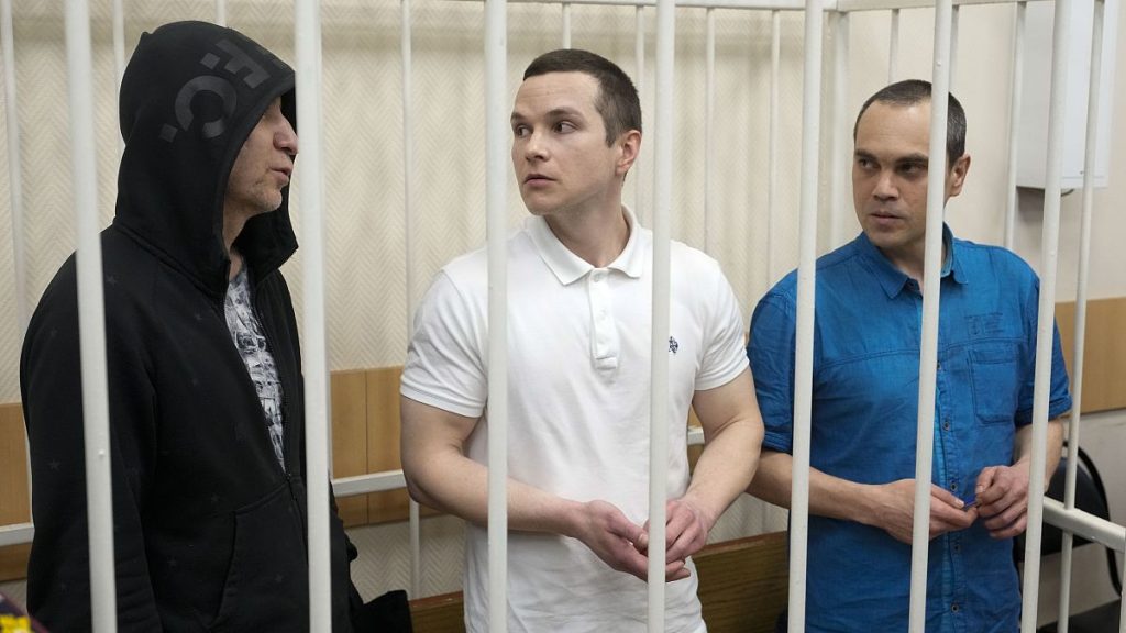 Lawyers Igor Sergunin, from left, Alexei Liptser and Vadim Kobzev, who all once represented late opposition leader Alexei Navalny, stand in a courtroom in Petushki