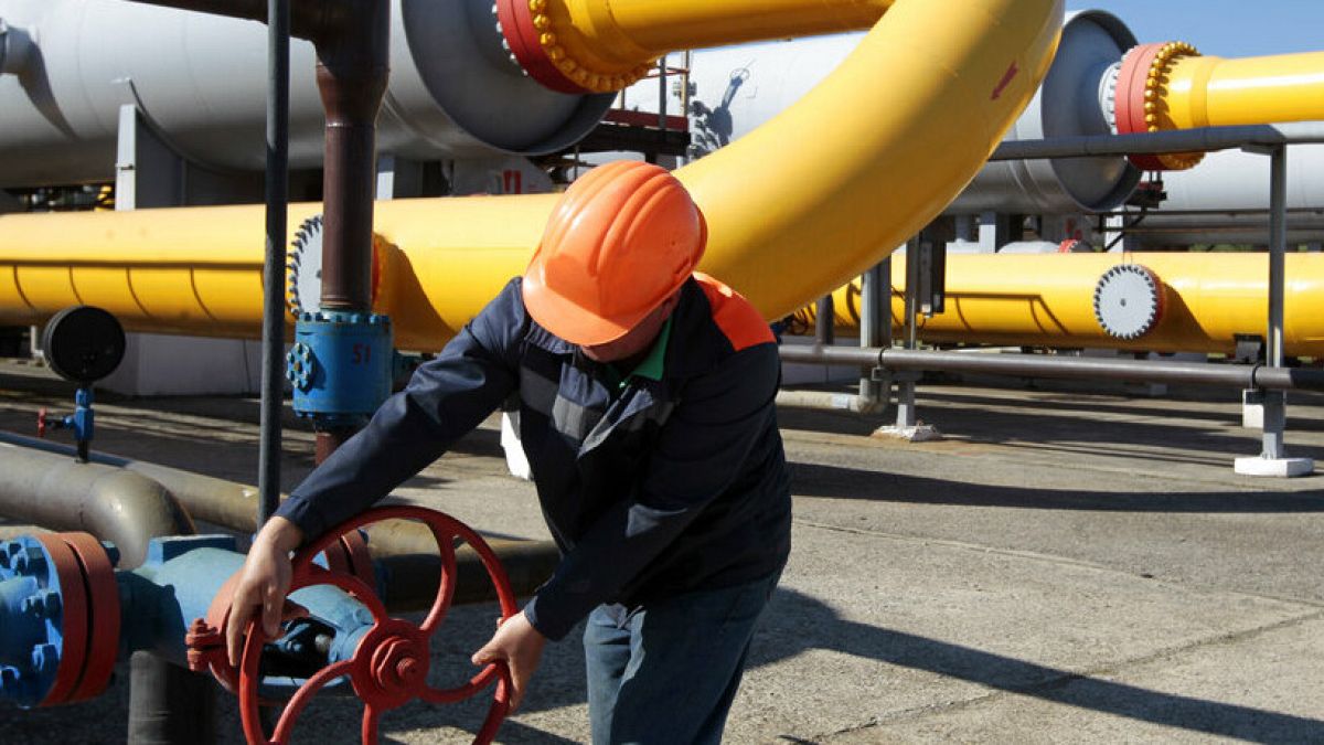 A Ukrainian worker operates valves in a gas storage point in Bil