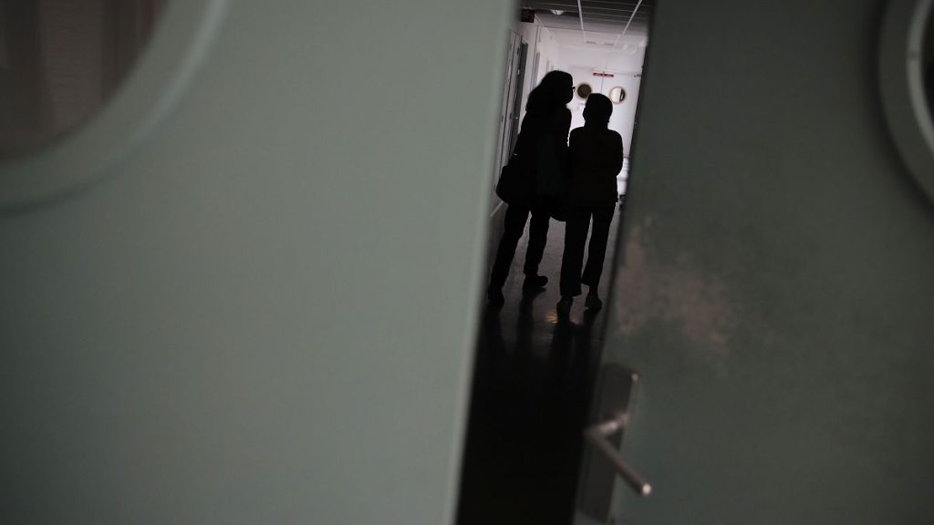 A young girl walks with her mother inside the pediatric unit of a Paris hospital in March 2021.