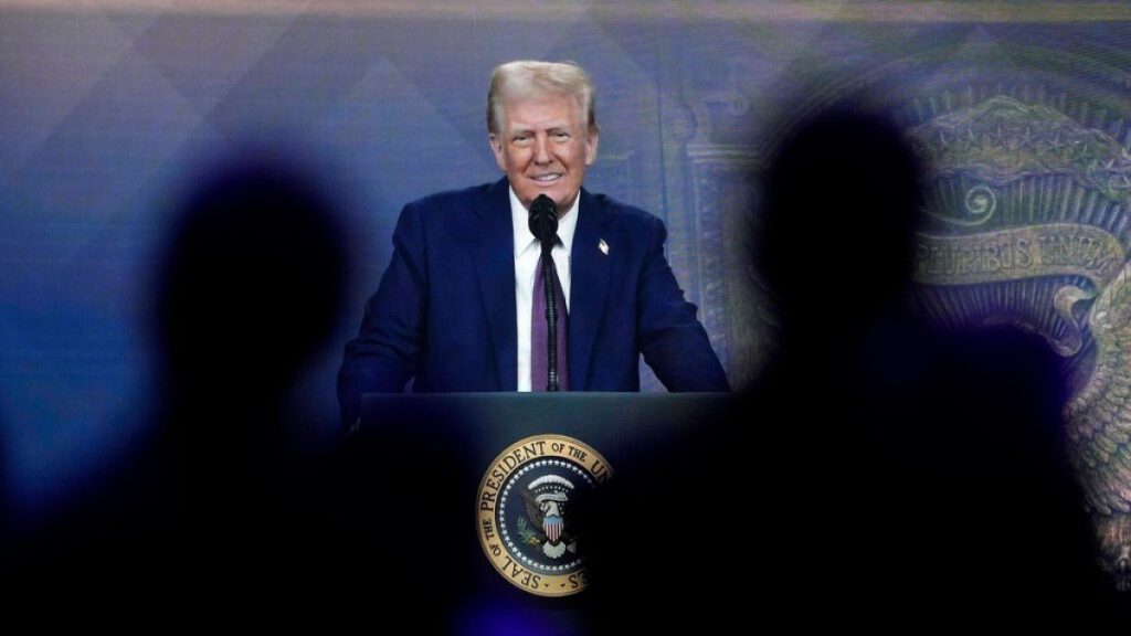 People follow a virtual speech of U.S. president Donald Trump at the Annual Meeting of World Economic Forum in Davos, Switzerland, Thursday, Jan. 23, 2025.