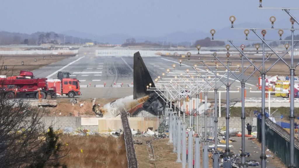 The wreckage of a Boeing 737-800 plane operated by South Korean budget airline Jeju Air lies at Muan International Airport in Muan, South Korea, Tuesday, December 31, 2024.