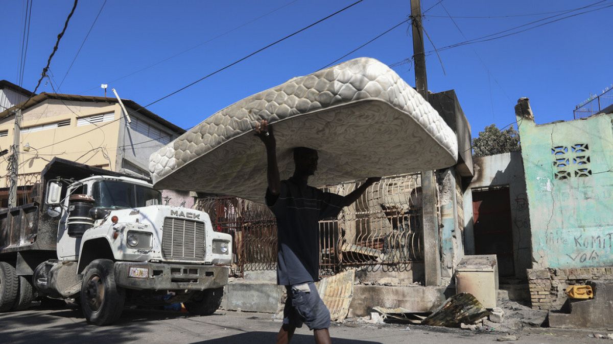 Residents move belongings out of their homes to escape gang violence in the Poste Marchand neighborhood of Port-au-Prince, Haiti, Tuesday, Dec. 10, 2024.