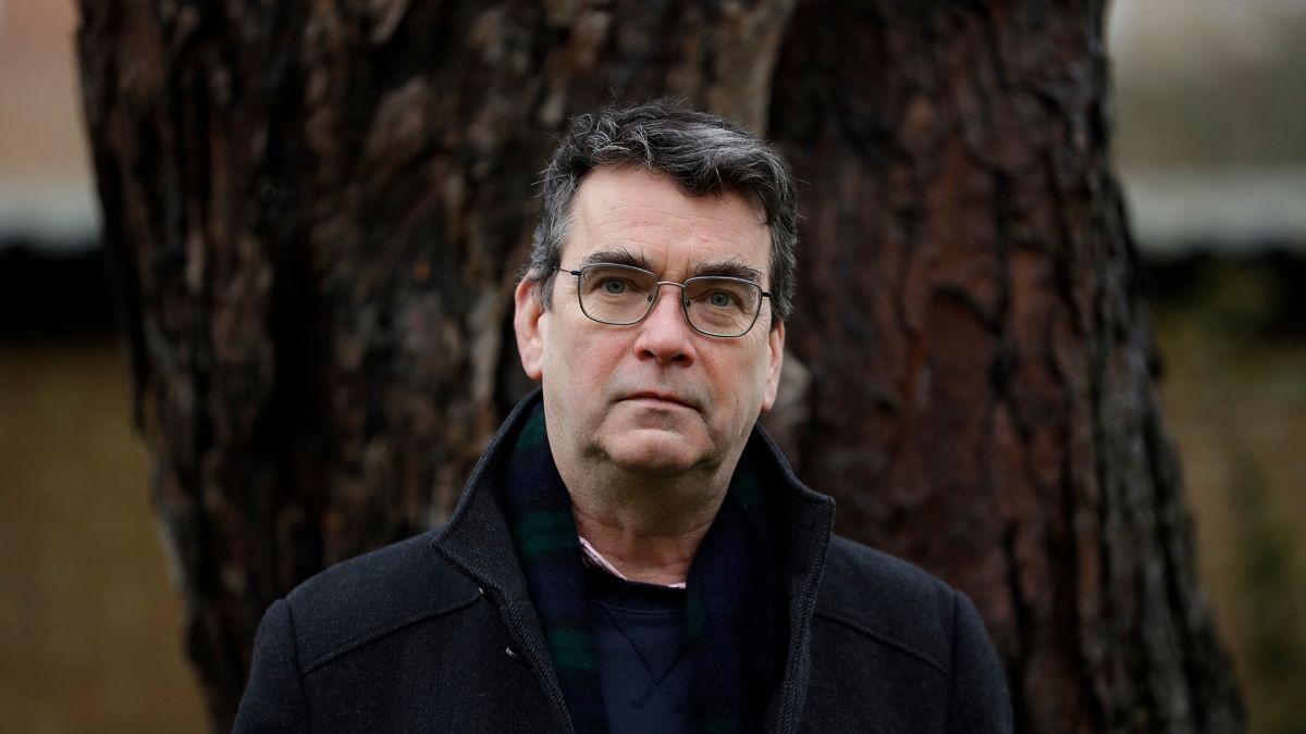 Mick Herron, the author of the Slough House espionage series, poses for photographs outside his home in Oxford, England, Wednesday, Jan. 27, 2021.