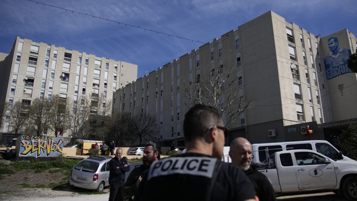 FILE: Police officers secure La Castellane district in Marseille, southern France, during a visit by French President Emmanuel Macron, Tuesday, March 19, 2024