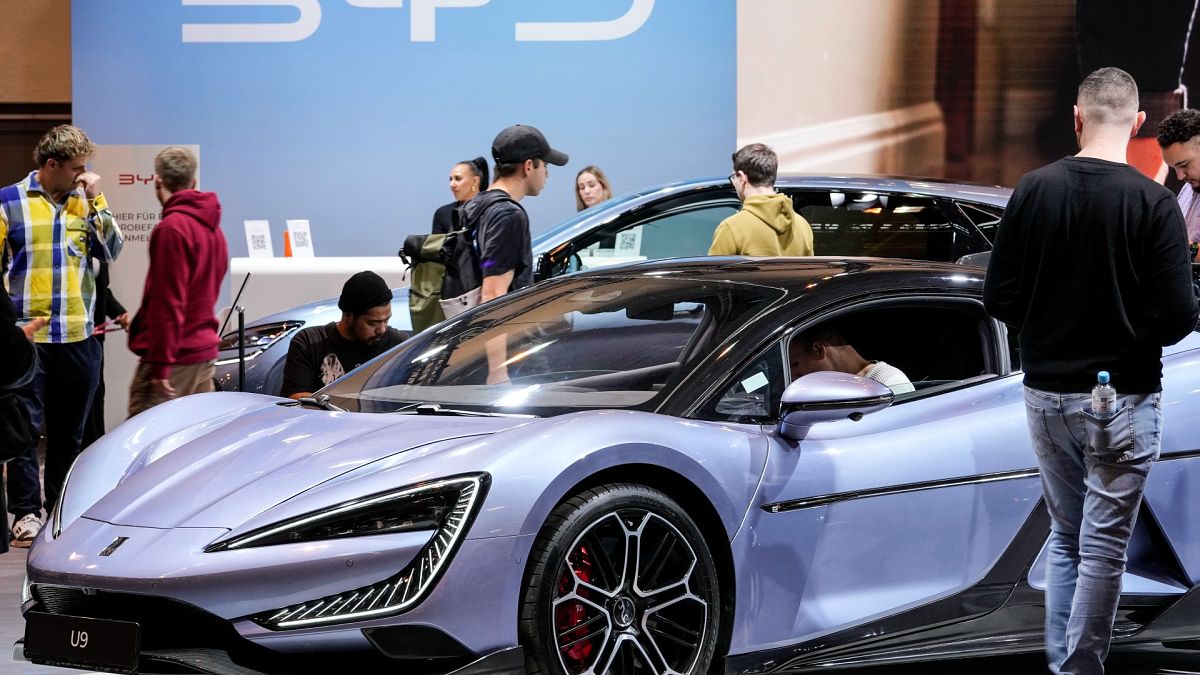 People visit the exhibition of Chinese electric car maker BYD at the Essen Motor Show in Essen, Germany, Friday, Nov. 29, 2024.