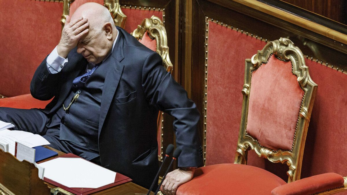 Justice Minister Carlo Nordio  puts his hand to his head during the presentation of the report on the justice administration, at the Senate, in Rome, Wednesday, Jan. 22, 2025